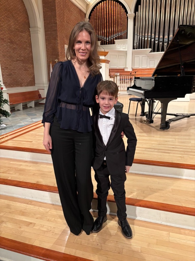 Maria with a young performer on stage